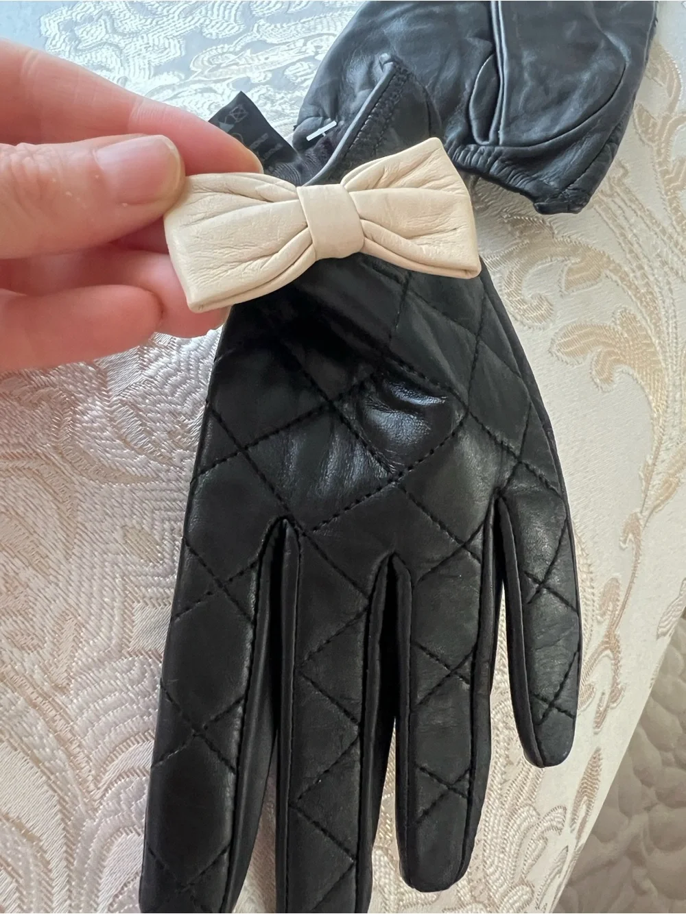 Black Quilted Leather Gloves with Beige Bow Accent